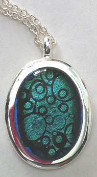 Click for a larger photo of the Clear Glass on Greenish Blue Bubble Patterned Oval in Silver-plated Setting