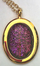 Click for a larger photo of the Clear Glass on Pinkish Purple Sparkle Patterned Oval in Gold-plated Setting