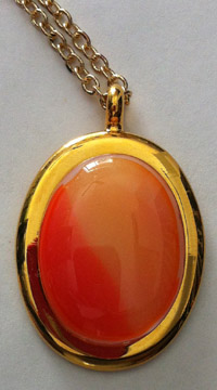 A larger photo of the Coral Glass Oval in Gold-plated Setting